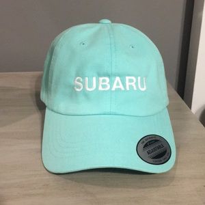 Women’s turquoise Subaru baseball cap.